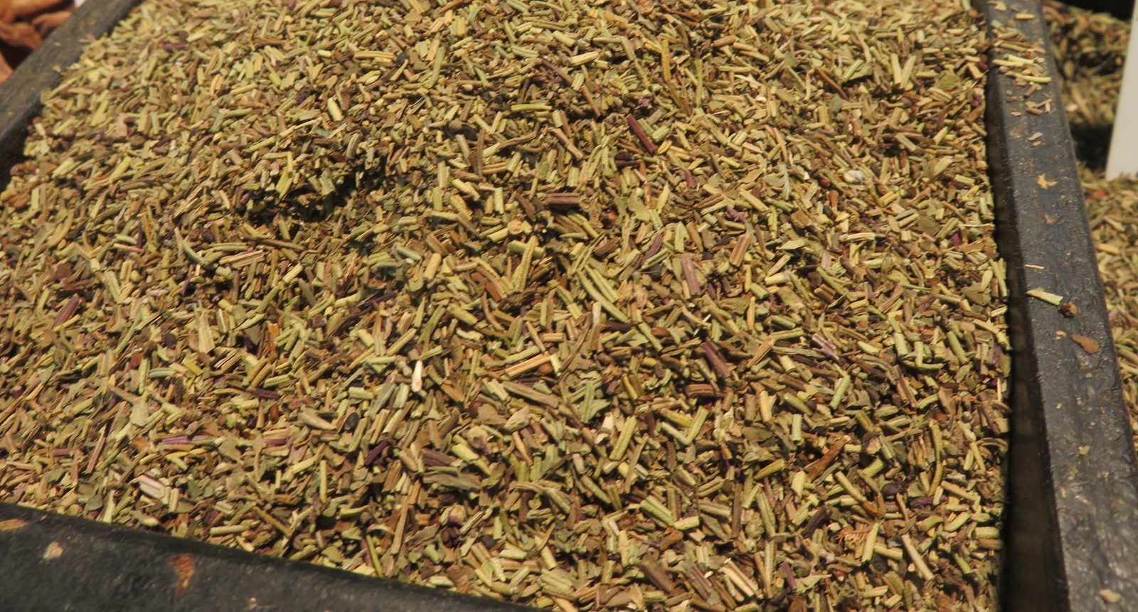 Heap of dried herbes de Provence in a market spice tray